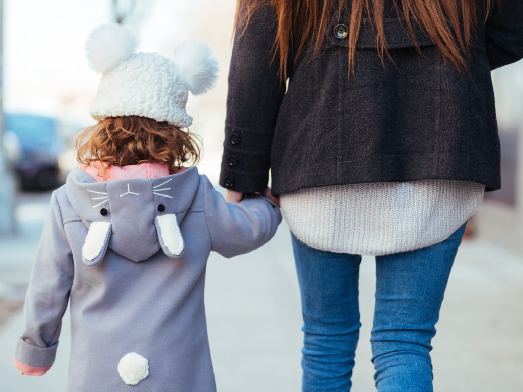 Child being walked away with mother